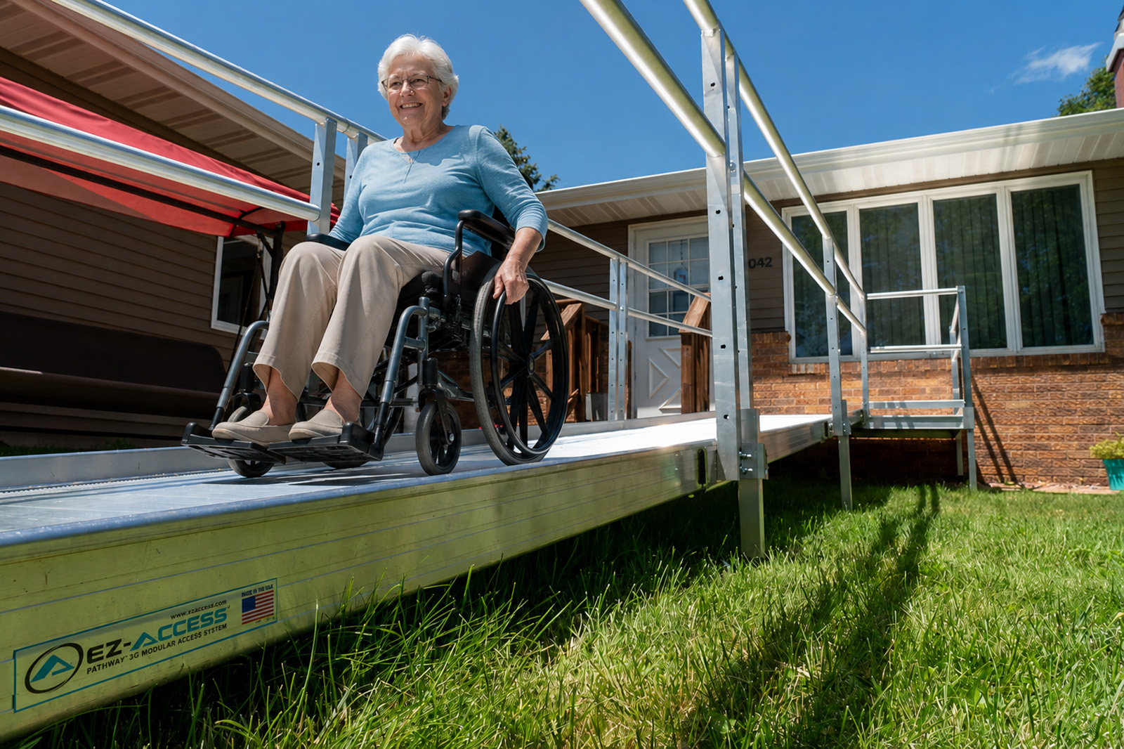 Wheelchair-accessible aluminum ramp leading to a residential front entry, installed by Aging In The Comfort Of Home®