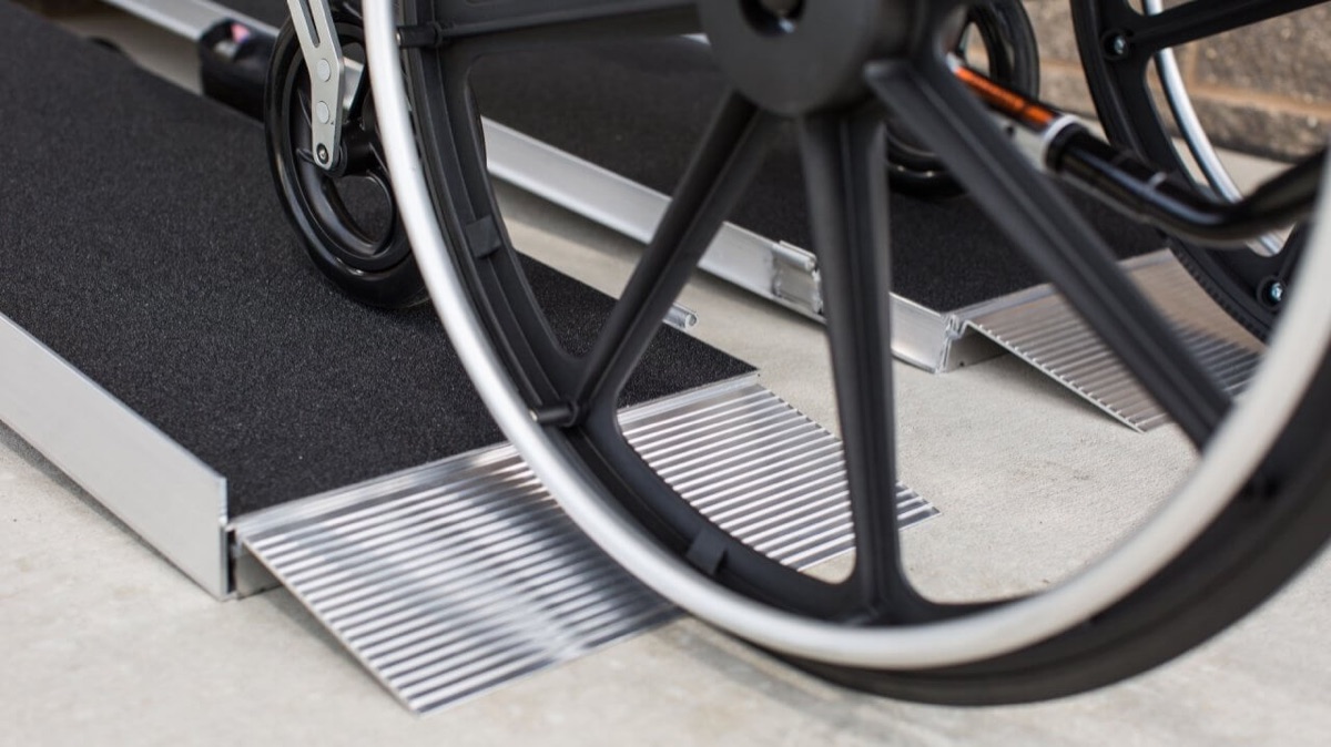 Wheelchair crossing a lightweight single-fold portable ramp
