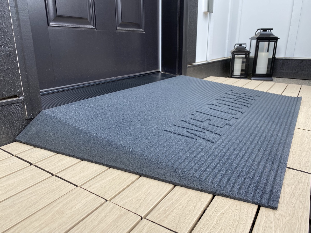 Angled entry mat forming a gentle, safe slope over a doorway threshold
